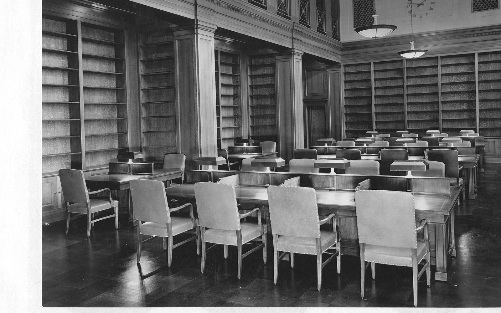 A public records counter with staff working, wide, flat light